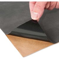 Black Trend Non Slip Mat with adhesive backing, shown being peeled by hand, revealing a brown underside.
