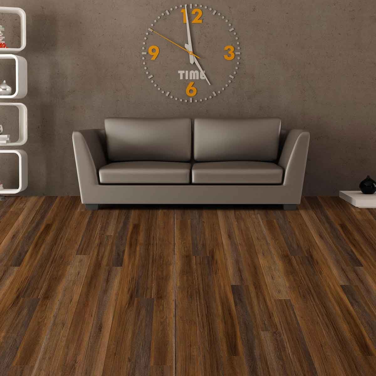 Umber brown wood look vinyl flooring with a barnwood oak design, featuring rich, warm tones, laid out beneath a modern gray sofa and a wall clock.