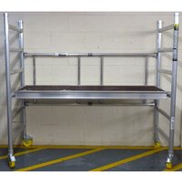 Aluminum Werner Mini-Max work tower with yellow wheels, adjustable platform, and safety rails.