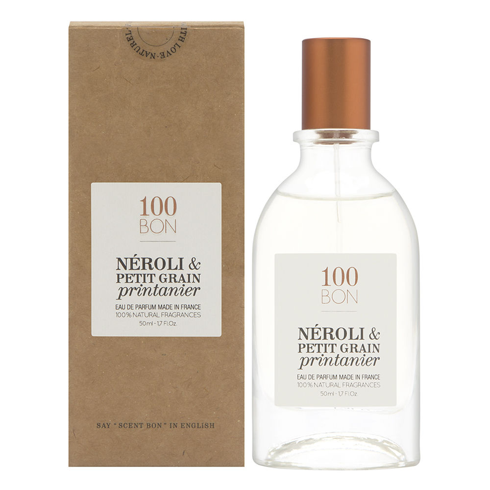 Clear glass bottle with a copper-colored cap, labeled "100BON NÉROLI & PETIT GRAIN Printanier," placed beside a brown cardboard box, both showcasing a fresh, natural aesthetic.