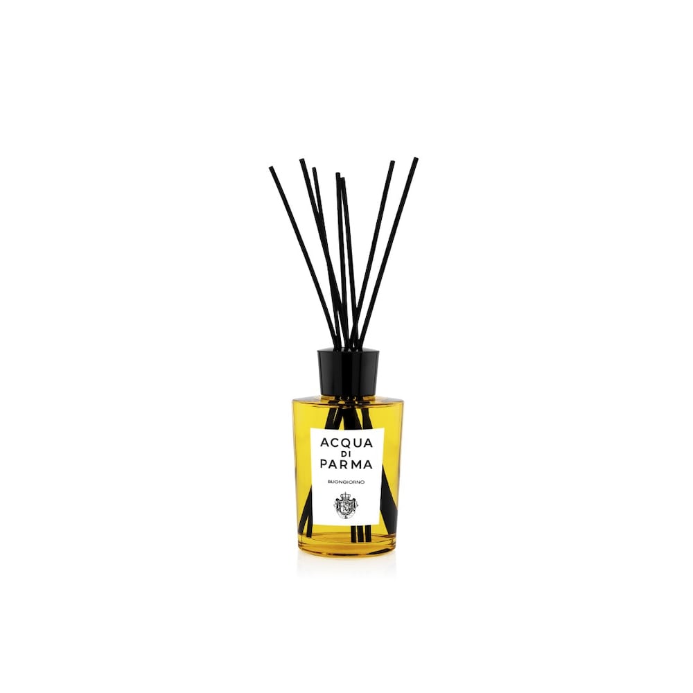 A sleek glass diffuser with a yellow liquid, featuring black reed sticks and a white label with black text, elegantly packaged for a sophisticated aroma experience.