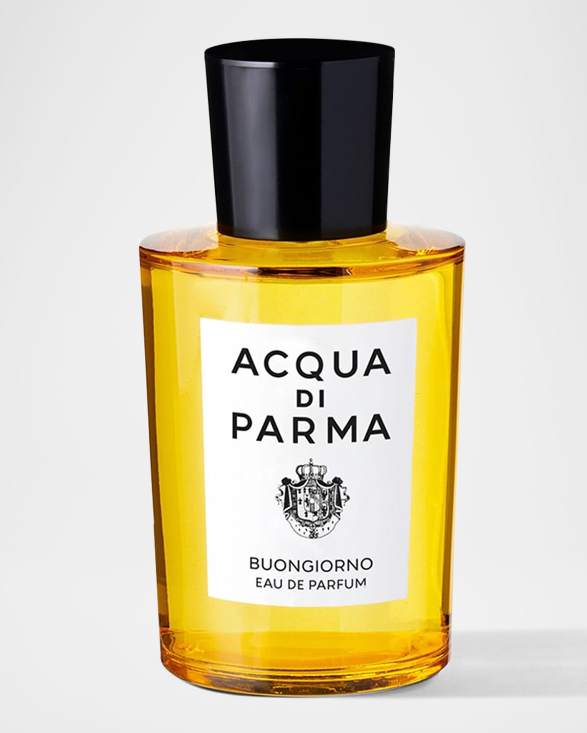 Clear glass bottle with a sleek, cylindrical shape, filled with vibrant yellow perfume, topped with a black cap and labeled "ACQUA DI PARMA BUONGIORNO EAU DE PARFUM."