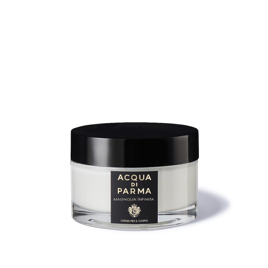 Luxurious white body cream in a clear glass jar with a sleek black lid, featuring a label that reads "Acqua Di Parma Magnolia Infinita" in elegant typography.