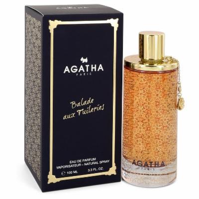 Clear glass perfume bottle with a textured amber design, gold cap, and a decorative chain, alongside a dark blue box featuring gold lettering and floral patterns.