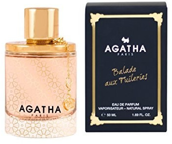 Clear glass perfume bottle with a gold cap and floral design, accompanied by a black box featuring gold text, labeled "Agatha Paris Balade Aux Tuileries Eau De Parfum 50ml Spray."