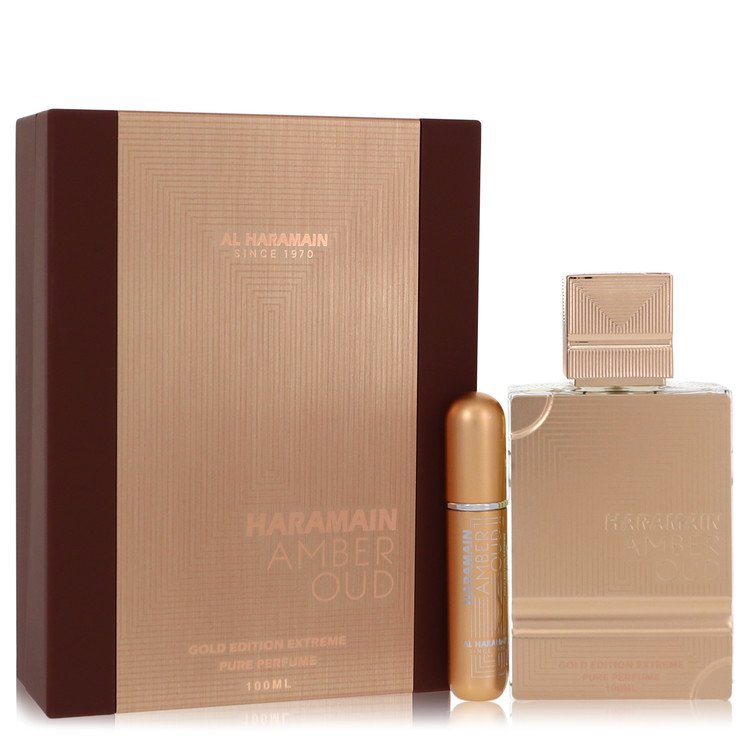 Elegant gold and brown packaging featuring "Al Haramain Amber Oud Gold Edition Extreme" label, with a 100 ml glass bottle and a gold rollerball perfume vial.