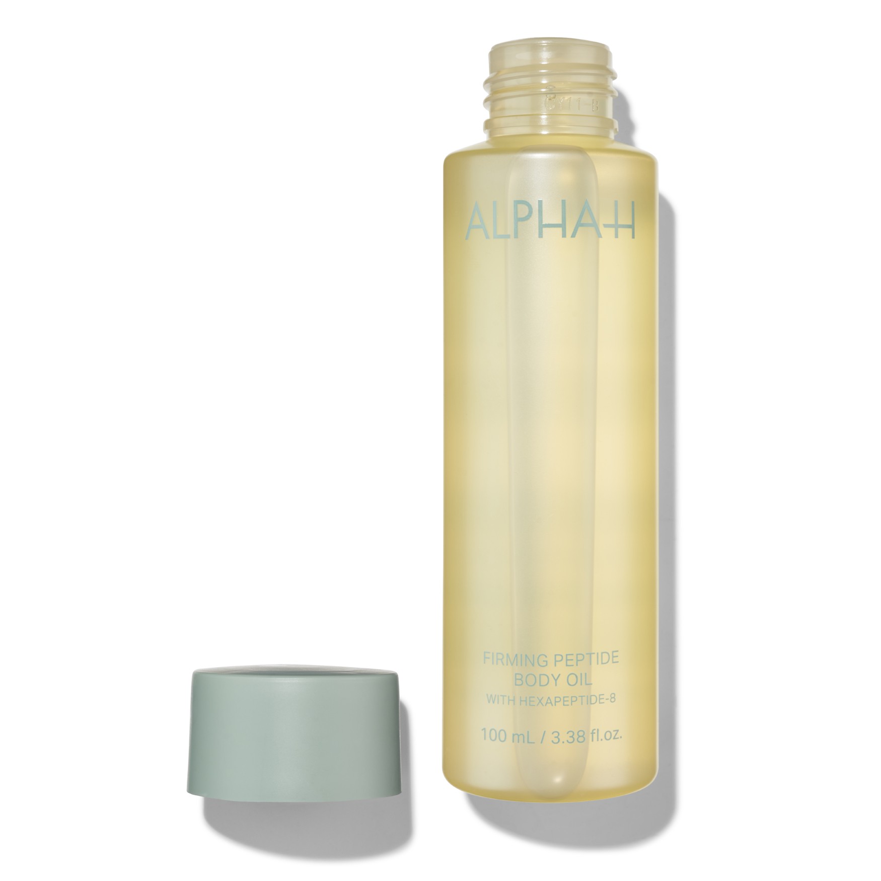 Clear, frosted bottle of Alpha-H Firming Peptide Body Oil, featuring a light yellow hue, with a mint green cap and blue text, containing 100ml of product.