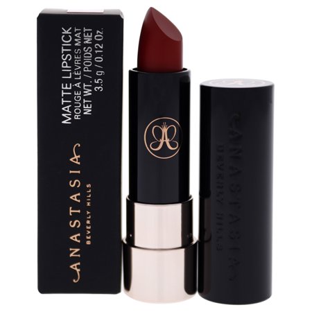Matte lipstick in a deep ruby red shade, housed in a sleek black tube with a gold logo, accompanied by a matching black box.