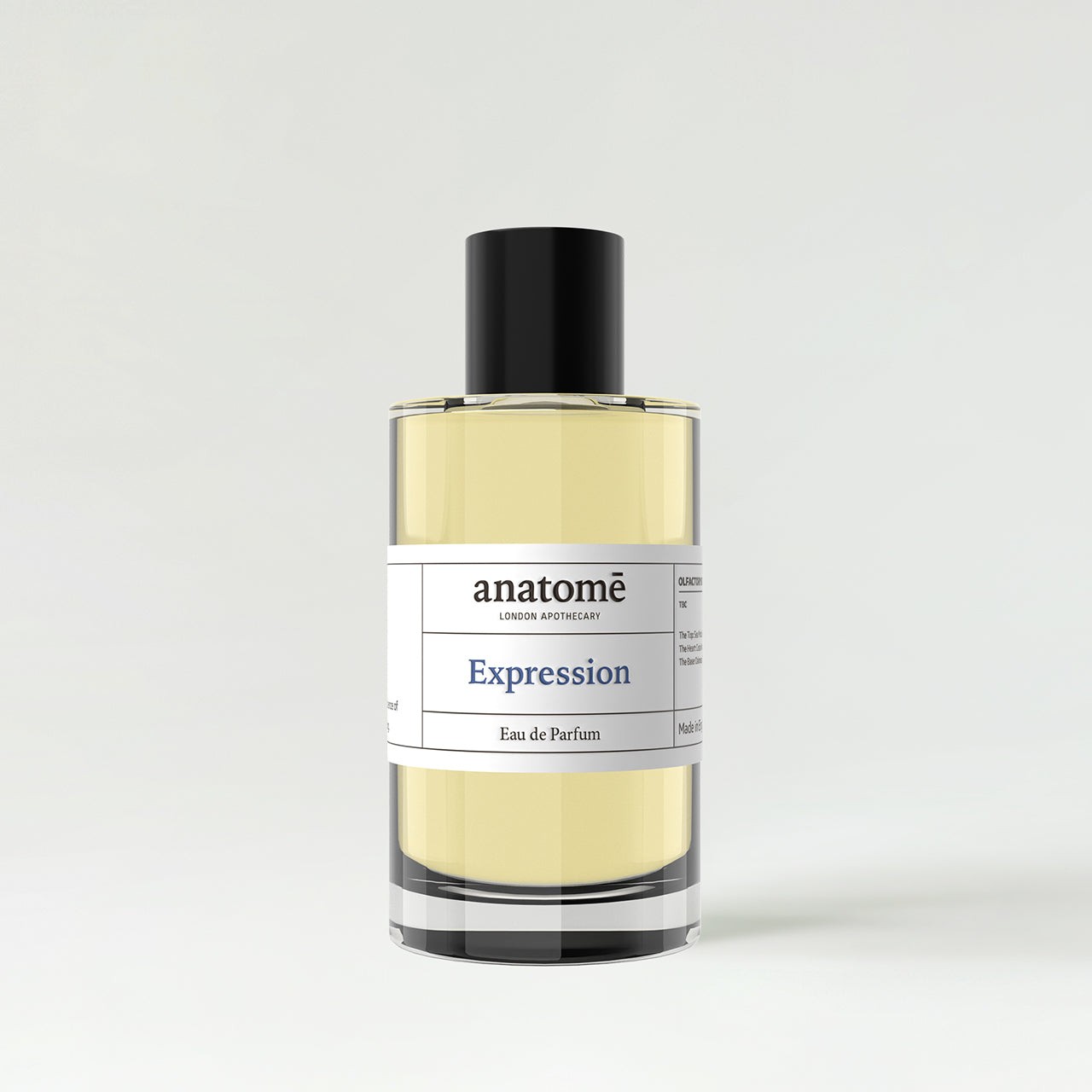 Clear glass bottle with a black cap, featuring a minimalist label that reads "anatomē Expression" in elegant font, containing a light yellow fragrance.