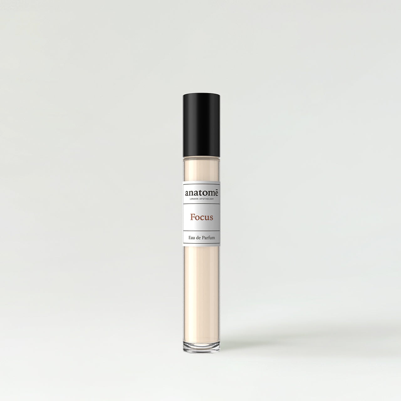 Clear glass 10ml perfume bottle with a sleek black cap, featuring a white label that reads "anatomē Focus Eau De Parfum" in elegant font.