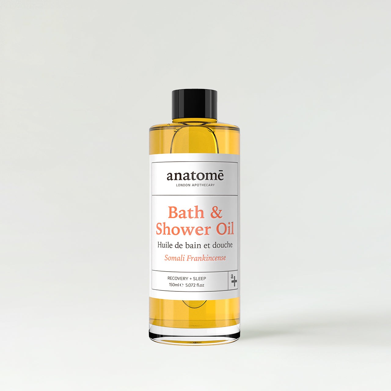 Transparent bottle containing golden bath and shower oil, labeled "Bath & Shower Oil Somali Frankincense" in white and orange text, with a sleek, modern design.
