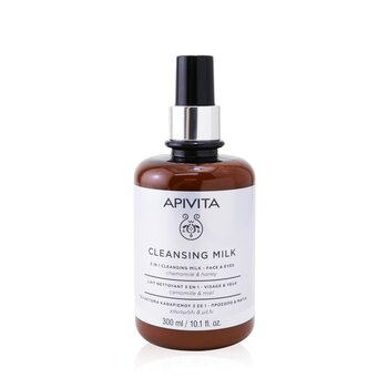 Brown glass bottle with a silver pump, labeled "APIVITA CLEANSING MILK," featuring a white background and black text, containing 300 ml of 3-in-1 cleansing lotion for face and eyes.