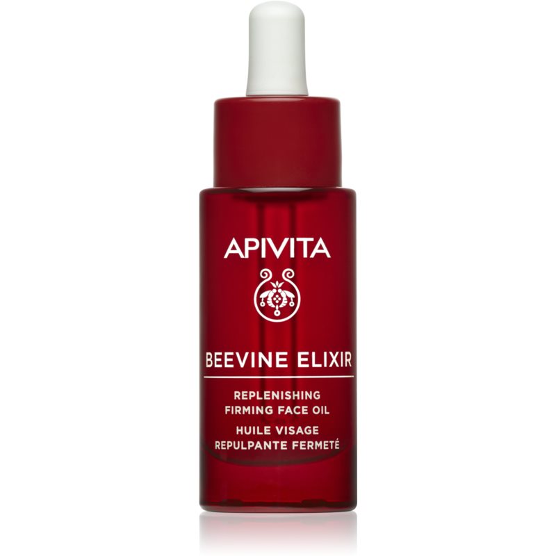 Red glass bottle of APIVITA Beevine Elixir Filling Facial Oil, featuring a dropper cap and white text highlighting its replenishing and firming properties.