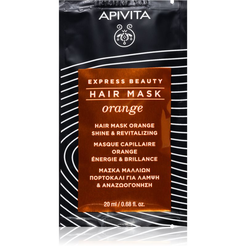 Black sachet with a glossy orange label featuring "APIVITA" and "Express Beauty Hair Mask Orange," highlighting benefits like shine and revitalization, 20 ml size.