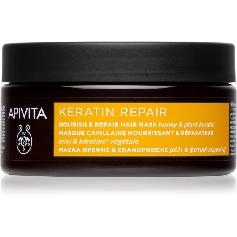 Black jar with a dark lid, labeled "APIVITA KERATIN REPAIR," featuring a vibrant orange and yellow design, highlighting nourishing ingredients like honey and plant keratin.