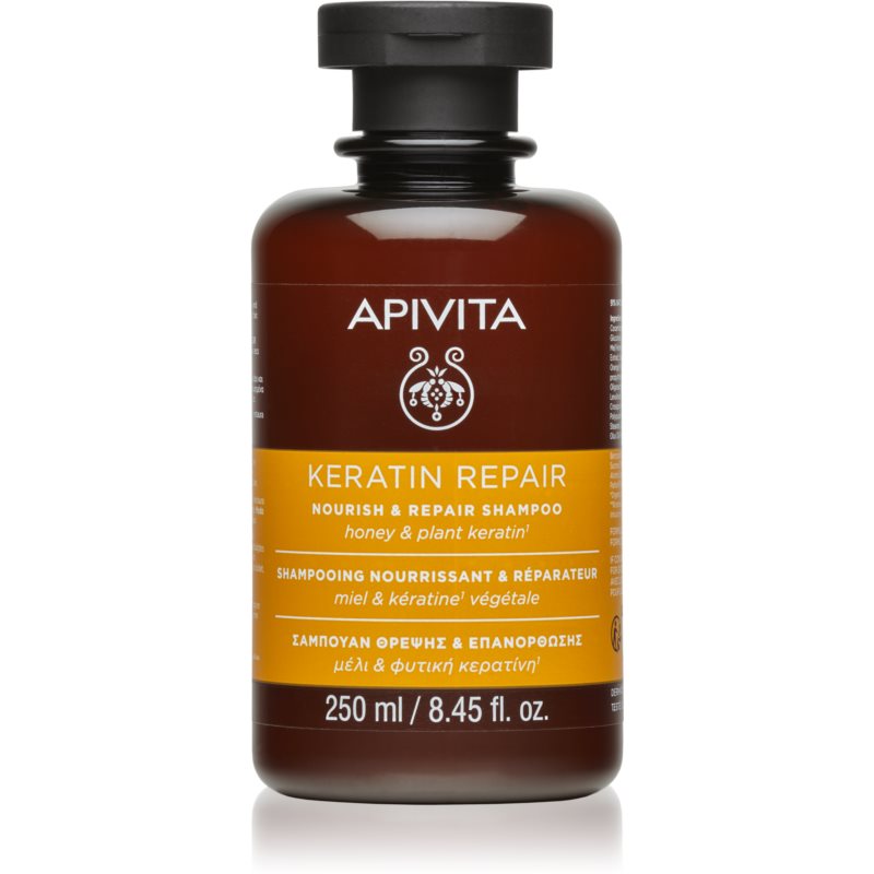 Brown glass bottle with a black cap, labeled "APIVITA KERATIN REPAIR" in white text, featuring honey and plant keratin, 250ml size.
