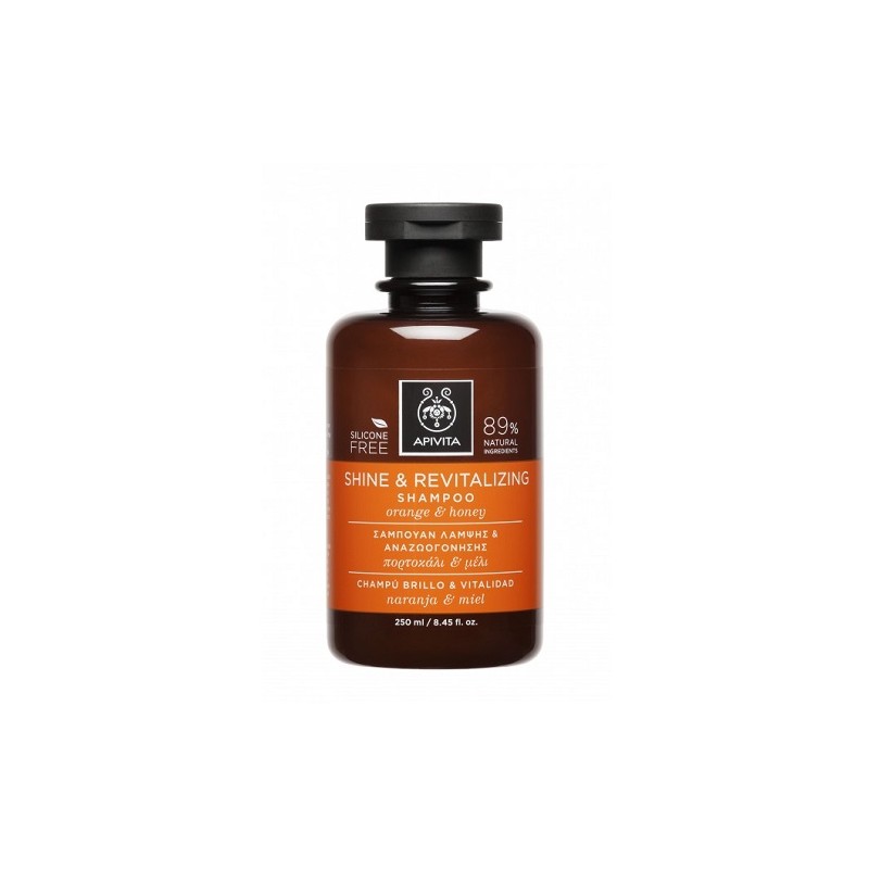 Brown glass bottle with a black cap, featuring an orange label that reads "Shine & Revitalizing Shampoo" and highlights ingredients like orange and honey, 250 ml size.