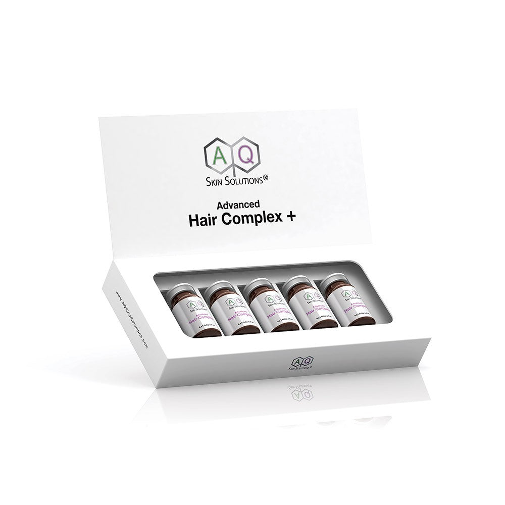 White box with a hinged lid containing five small brown vials labeled "AQ Skin Solutions Advanced Hair Complex +" in purple and green text.