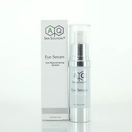 Clear glass bottle with a silver pump top, labeled "AQ Skin Solutions Eye Serum" in elegant font, alongside a white box with green and purple accents.