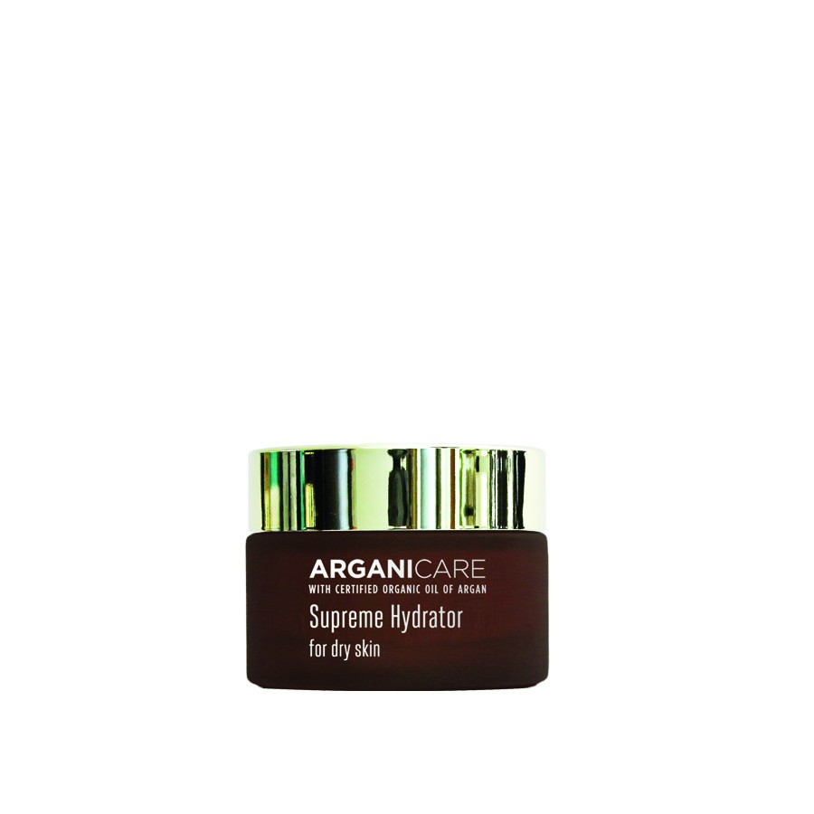 Brown glass jar with a silver lid, labeled "ARGANICARE Supreme Hydrator for dry skin," featuring organic argan oil, designed for moisturizing and nourishing dry skin.
