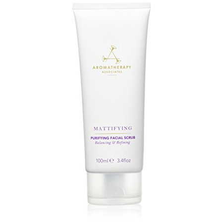 White tube with a flip-top cap, labeled "Mattifying Purifying Facial Scrub" in gold and purple text, containing 100 ml of vegan exfoliating scrub by Aromatherapy Associates.