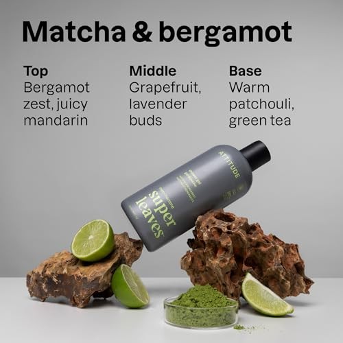 Dark gray bottle of ATTITUDE Super Leaves™ Shower Gel for Men, featuring matcha and bergamot, with green accents and a black cap, surrounded by lime slices and natural elements.