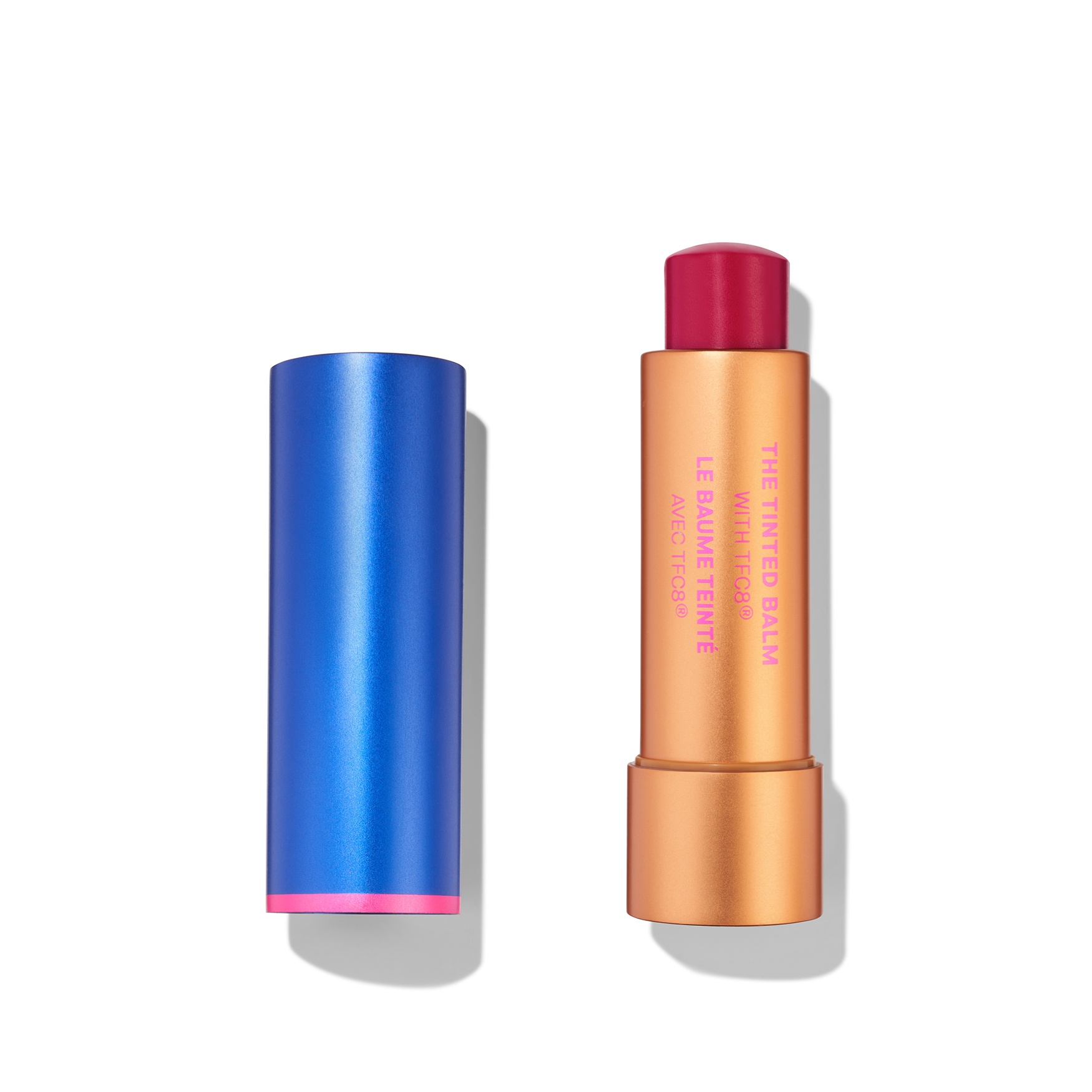 Tinted balm in a sleek gold tube with pink accents, featuring a vibrant red shade, displayed next to a shiny blue cap.
