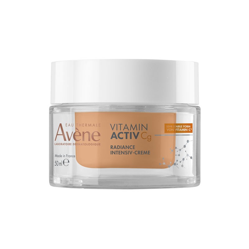 Avene Vitamin Active CG Cream in a clear glass jar with a white lid, featuring a light orange cream inside, labeled with "Vitamin Activ Cg" and "Radiance Intensiv-Crème."