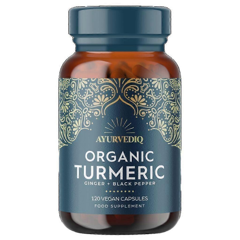 Brown glass bottle with a blue label featuring intricate gold designs, labeled "Ayurvediq Organic Turmeric," containing 120 vegan capsules with ginger and black pepper extract.