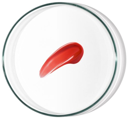 Bright red lip and cheek cream in a glossy texture, displayed in a clear glass container, showcasing a smooth swatch of the product.