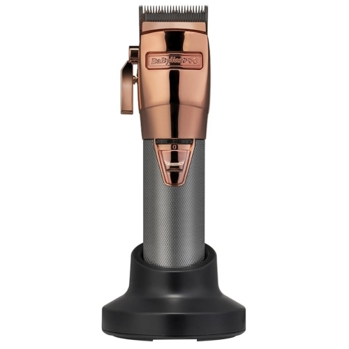 Cordless hair clipper with a rose gold and silver finish, featuring a textured grip, adjustable lever, and a sleek charging base for easy storage.