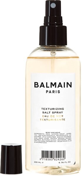 Clear plastic bottle with a black spray nozzle, featuring a white label that reads "BALMAIN PARIS TEXTURIZING SALT SPRAY" in bold black text, 200ml size.