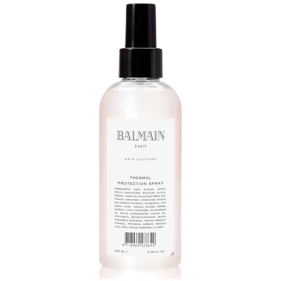 Clear plastic bottle with a black spray nozzle, featuring a white label that reads "BALMAIN PARIS" and "THERMAL PROTECTION SPRAY," designed for heat treatment of hair, 200 ml.