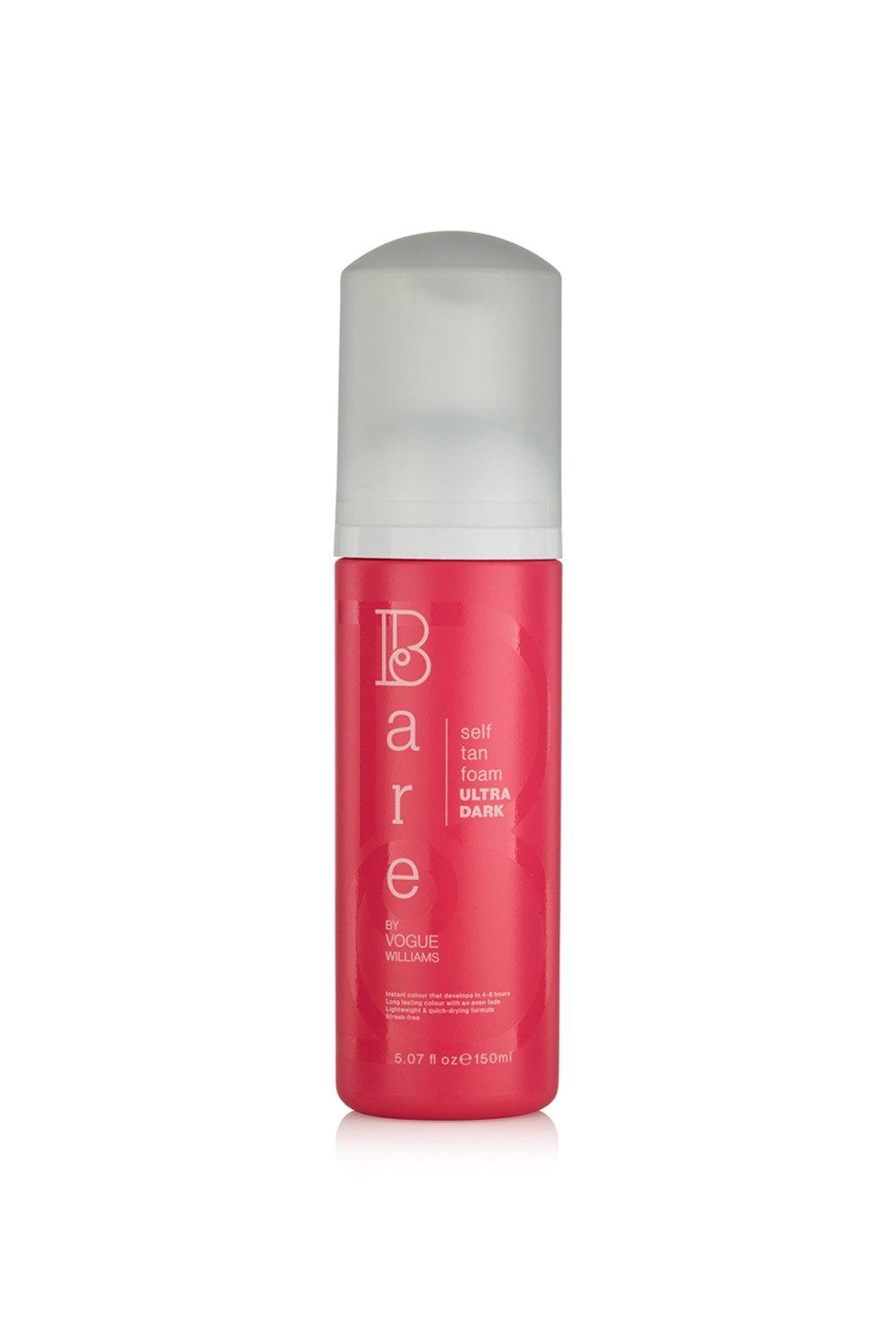 Debenhams Self Tan Foam in Ultra Dark, 150ml, features a vibrant pink bottle with a white pump top, labeled with "Bare" and "Vogue Williams" in stylish fonts.