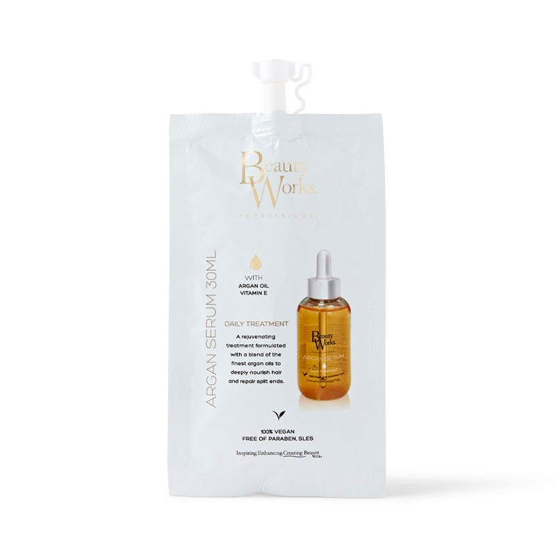 Beauty Works Argan Oil Serum in a sleek, gold and white pouch with a dropper cap, labeled as 30ml, featuring key ingredients like argan oil and vitamin E, and marked as vegan.
