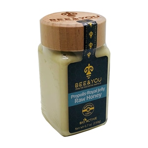 Glass jar with a wooden lid, containing a creamy yellowish raw honey mix labeled "Propolis Royal Jelly Raw Honey" by BEE&YOU, 6.7 oz size.