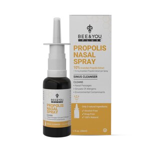 BEE&YOU Propolis Nasal Spray bottle in a dark brown glass with a white nozzle, accompanied by a light-colored box featuring product details and branding.