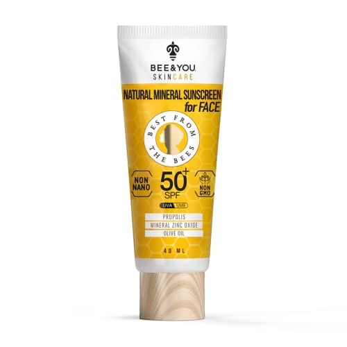 Natural mineral sunscreen cream in a white and yellow tube, featuring a wooden cap, labeled "Bee & You" with "50+ SPF" and "1.35 Fl Oz" prominently displayed.