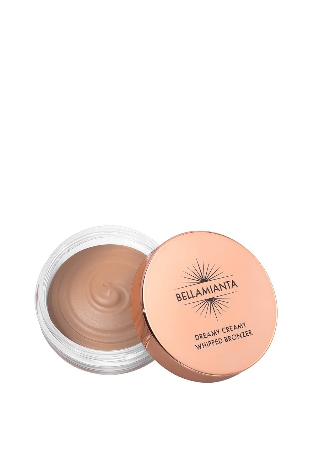 Light bronze whipped bronzer in a clear jar with a rose gold lid, labeled "BELLAMIANTA DREAMY CREAMY WHIPPED BRONZER 23G." The creamy texture is visible inside the container.