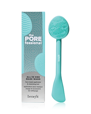 Turquoise silicone face mask applicator with a textured oval head and a flat spatula end, packaged in a matching box featuring a dotted design and the Benefit logo.