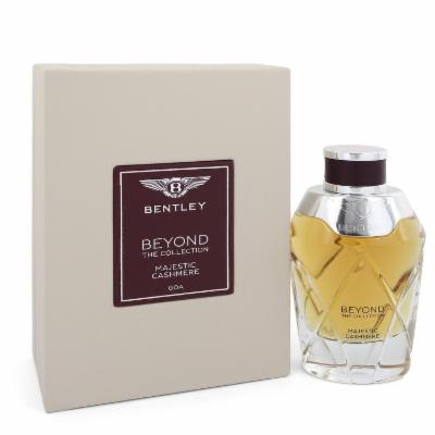 Clear glass bottle with a faceted design, filled with golden liquid, alongside a beige box featuring a dark brown label that reads "Bentley Beyond the Collection Majestic Cashmere."