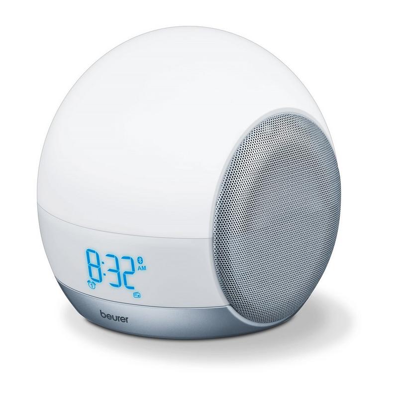 Round white wake-up light with a silver speaker grille, blue digital clock display showing 8:32 AM, designed for mood enhancement and gradual light simulation.