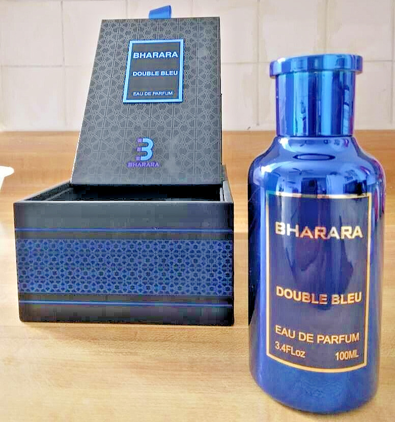 Bharara Double Bleu Eau De Parfum in a sleek blue glass bottle, featuring a silver label, displayed beside its elegant black box with blue accents.