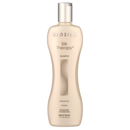Biosilk Silk Therapy Shampoo in a sleek, beige bottle with a silver cap, featuring a textured stripe design, labeled for unisex use, 12 oz size.