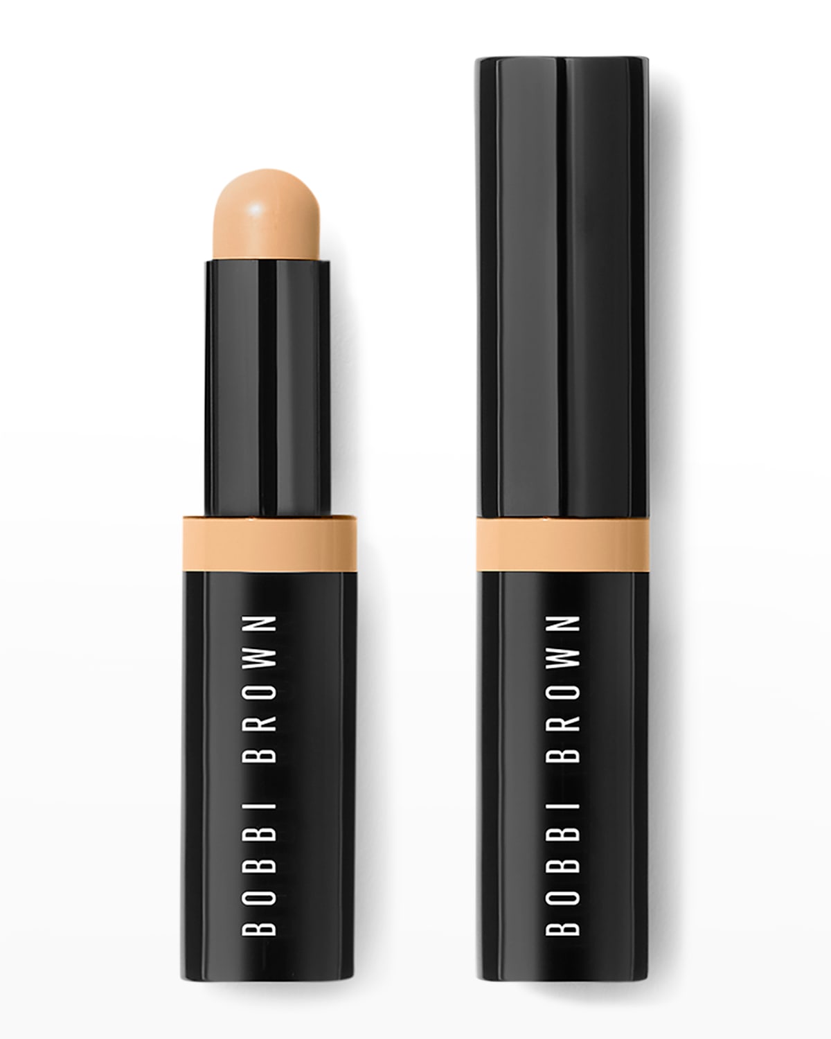 Bobbi Brown Skin Concealer Stick in Almond, featuring a sleek black casing with a twist-up design and a creamy, light tan concealer tip.