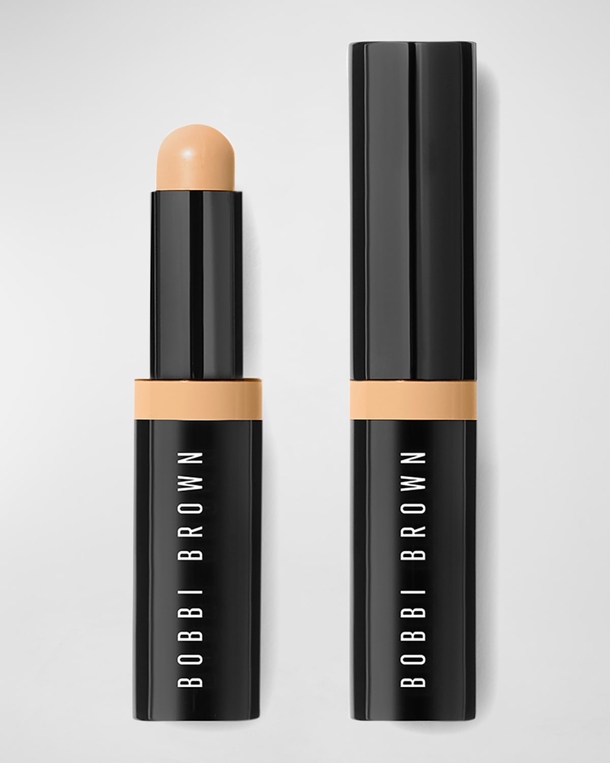 Bobbi Brown Stick Concealer in shade 3 G Beige, featuring a sleek black tube with a twist mechanism and a rounded beige concealer tip.