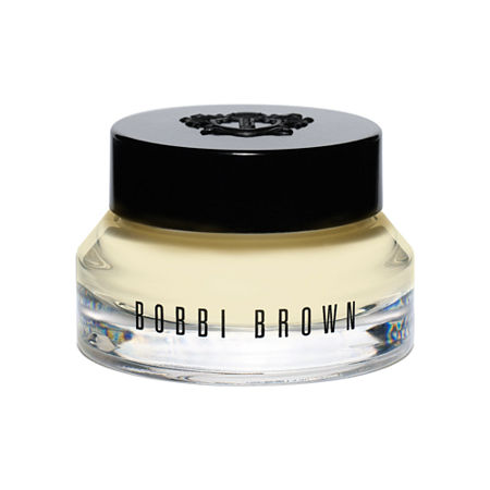 Clear glass jar with a black lid, containing a creamy, pale yellow moisturizer labeled "BOBBI BROWN" on the front, designed for use as a primer and moisturizer.