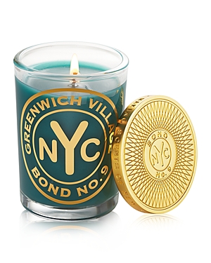 Greenwich Village scented candle in a teal glass container, featuring a gold NYC logo and a decorative gold lid with a sunburst design, 6.4 oz size.