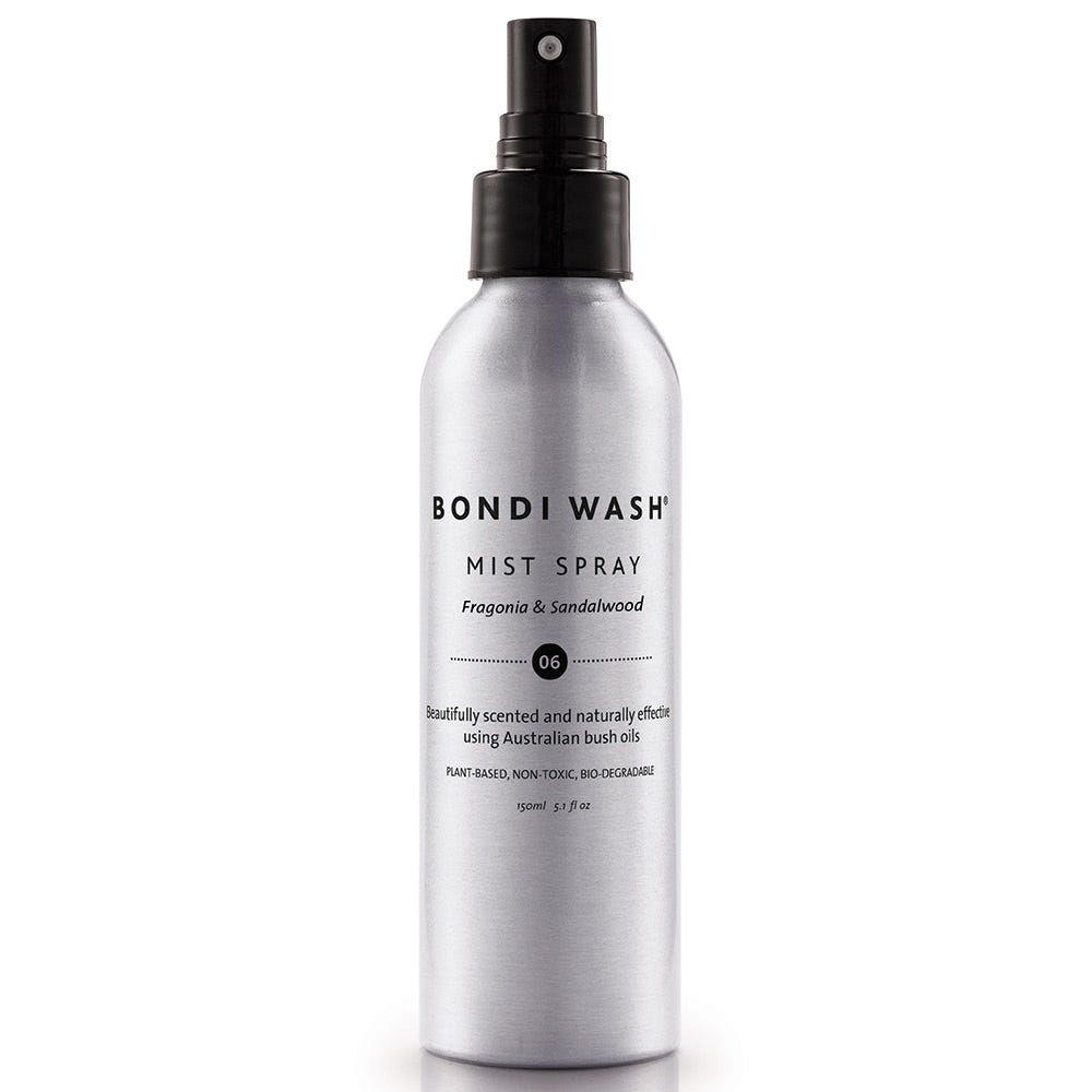Silver aluminum spray bottle with a black pump top, labeled "BONDI WASH Mist Spray" in bold black text, featuring a subtle design and a description of the fragrance, Fragonia & Sandalwood.