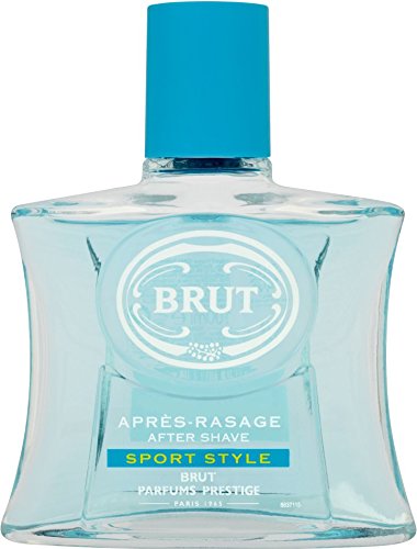 Clear glass bottle with a square shape, featuring a light blue liquid, a white circular logo, and a blue label reading "Brut Après Rasage Sport Style."